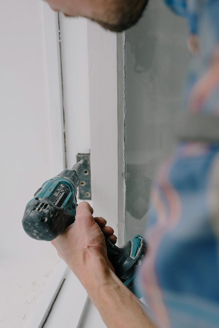 Crafting Captivating Headlines: Your awesome post title goes here Crop bearded guy installing new wooden window with contemporary screwdriver and metal hinge during renovation process in apartment